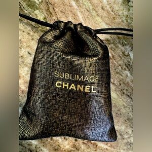 Chanel sublimage drawstring bag black and gold with goodies